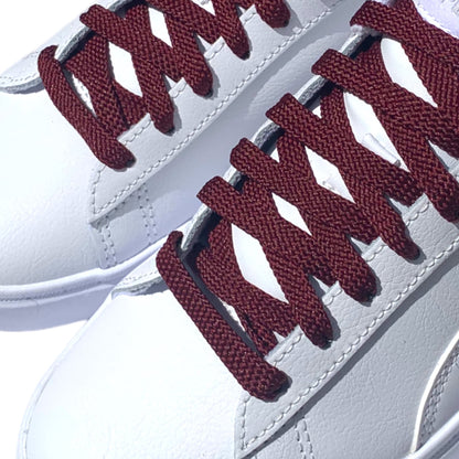 Maroon Shoelaces closeup in white sneakers