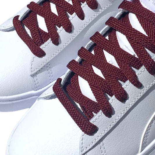 Maroon Shoelaces closeup in white sneakers